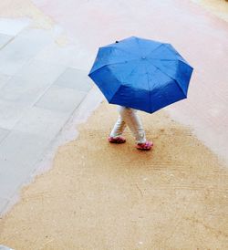 Low section of woman walking in water