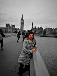 Full length portrait of woman standing in city