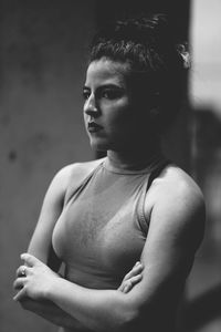 Thoughtful confident woman standing with arms crossed