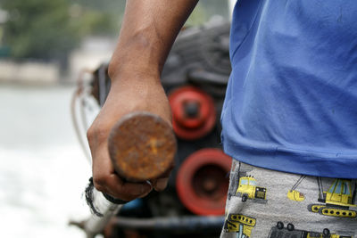 Midsection of man pulling cart