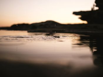 Surface level of lake at sunset