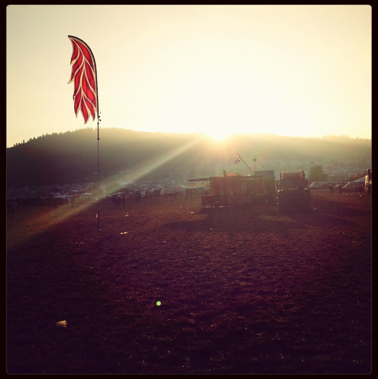 transfer print, auto post production filter, sun, red, clear sky, sky, sunlight, field, flag, landscape, nature, outdoors, beauty in nature, day, tranquil scene, tranquility, scenics, no people, sunbeam, american flag