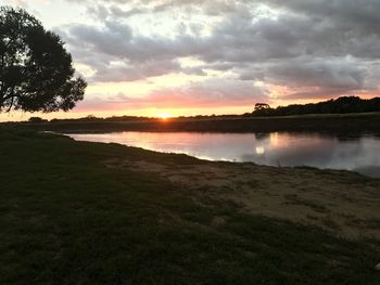 Scenic view of lake against sky during sunset