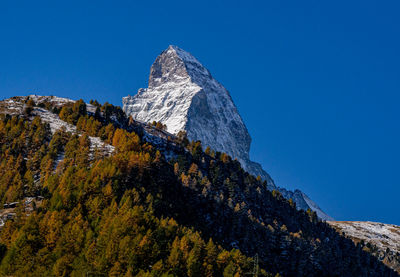 Low angle view of mountain against clear blue sky - matterhorn