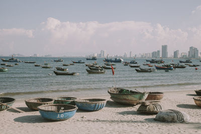 Boats moored in sea against sky