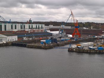 Harbor against cloudy sky