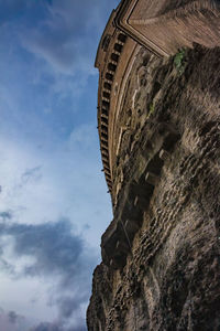 Low angle view of historical building against cloudy sky