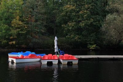 Boat in lake against trees