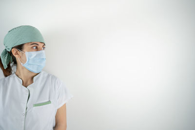 Portrait of man wearing mask against white background