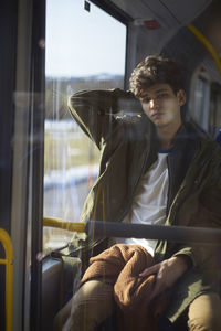 Portrait of man sitting in train