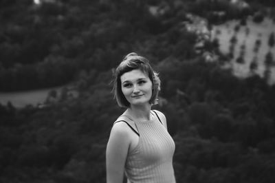 Smiling woman looking away while standing outdoors