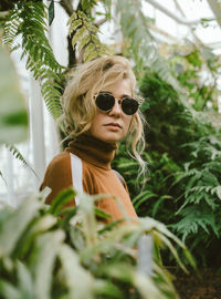 Portrait of a young woman in a botanical garden