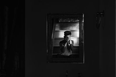 Woman standing by window at home