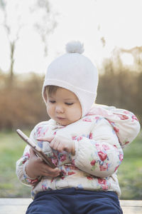 Portrait of cute girl sitting on field