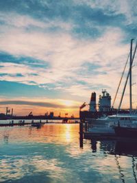Boats in harbor at sunset
