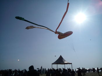 People flying against clear sky