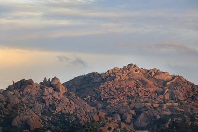 Scenic view of rocky mountains against sky during sunset