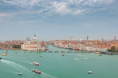 View of boats in sea against buildings in city 