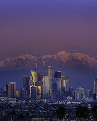 Illuminated buildings in city against sky