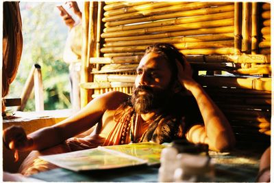 Young man sitting on table at restaurant