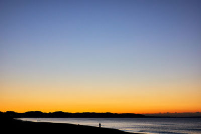 Scenic view of sea against clear sky during sunset
