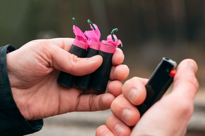Cropped image of hand holding mobile phone