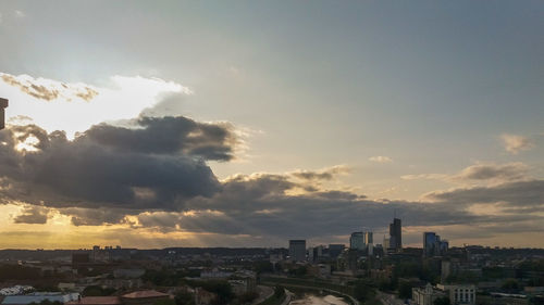 Buildings in city against sky during sunset