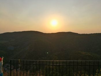 Scenic view of mountains against sky at sunset