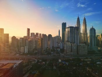 View of buildings in city at sunset