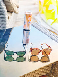 Close-up of sunglasses on glass table
