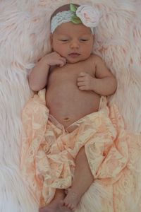 High angle view of cute baby on bed