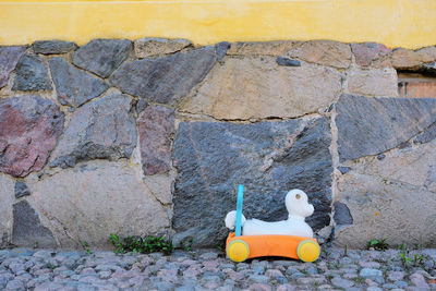Toy car on stone wall