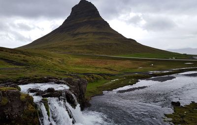 Scenic view of mountain against cloudy sky