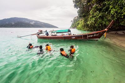 People in boat on sea