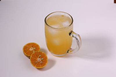 Close-up of drink on table against white background