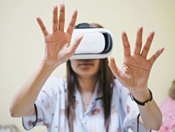 Woman gesturing while using virtual reality simulator