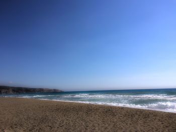 Scenic view of sea against clear blue sky