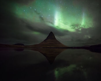 Scenic view of lake against sky at night