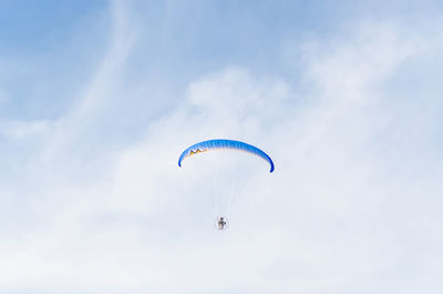 Low angle view of person paragliding against clear sky