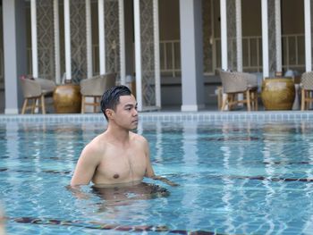 Shirtless young man in swiming pool