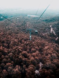 Overhead cable car over mountains against sky