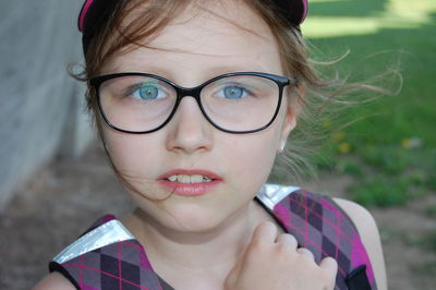 Portrait of girl wearing eyeglasses standing outdoors