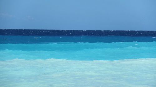 Scenic view of sea against clear blue sky