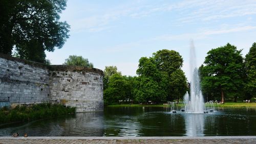 Castle by trees against sky