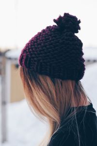 Close-up of woman wearing knit hat during winter