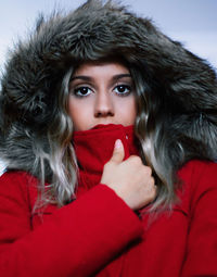 Close-up portrait of young woman wearing red warm clothing