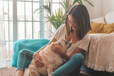 Girl with dogs sitting at home