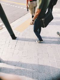 Low section of people walking on footpath