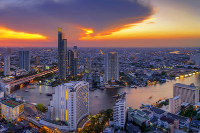 High angle view of modern buildings against sky during sunset