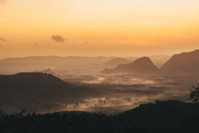 Scenic view of silhouette mountains against sky during sunset